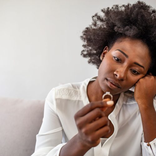 Unhappy woman holding wedding ring close up, upset girl crying, depressed with divorce, break up with boyfriend, broken engagement, feeling desperate, family split, bad relationships